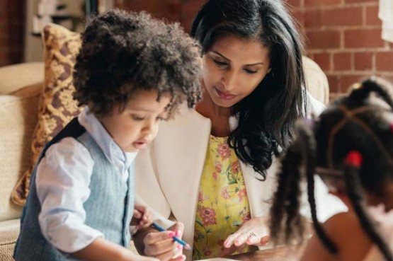 a mother drawing with a young son and daughter